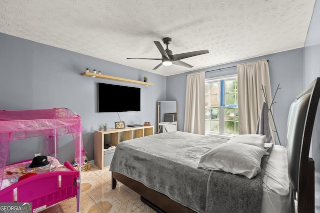 bedroom with a textured ceiling and ceiling fan