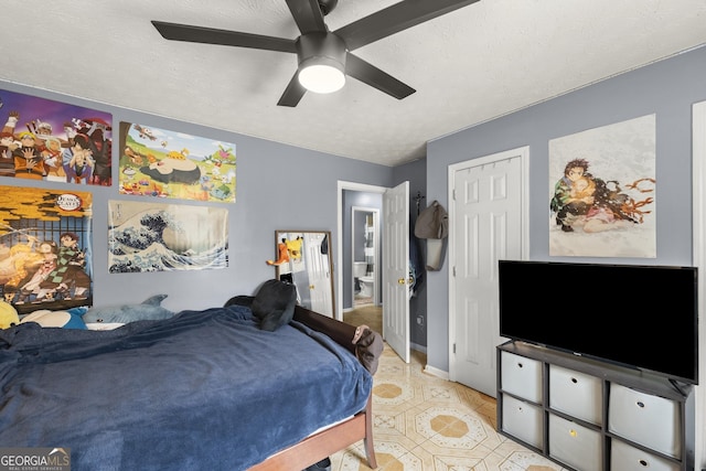 tiled bedroom featuring a closet, ceiling fan, and a textured ceiling