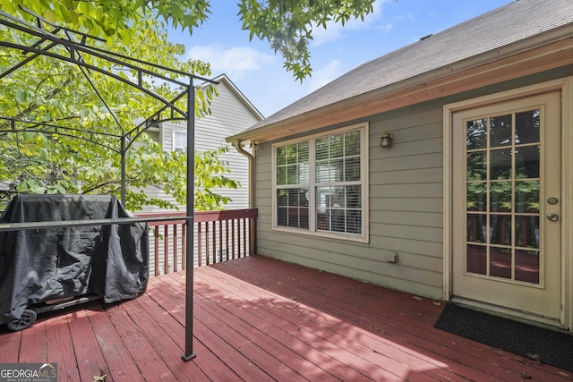 wooden deck featuring a grill