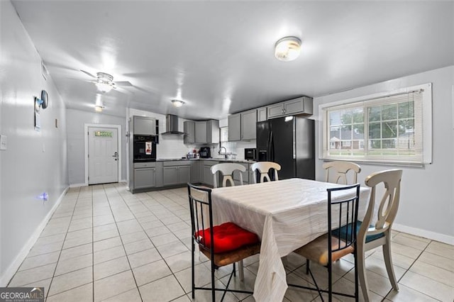 tiled dining space featuring sink and ceiling fan