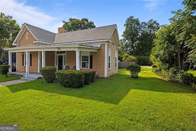 view of front of property with covered porch and a front yard