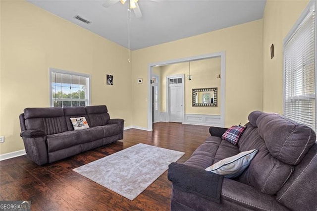 living room featuring ceiling fan and dark hardwood / wood-style flooring