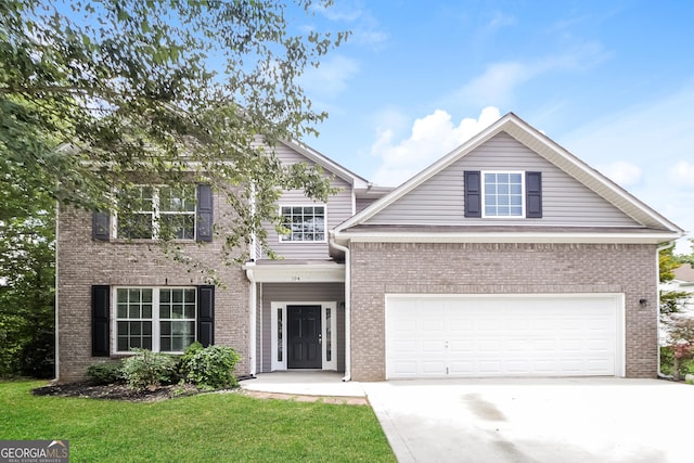 view of front of home with a garage and a front yard