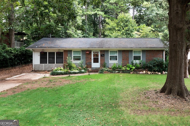 ranch-style house with brick siding and a front lawn
