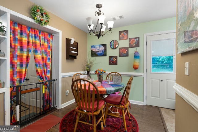 dining area with an inviting chandelier and hardwood / wood-style floors