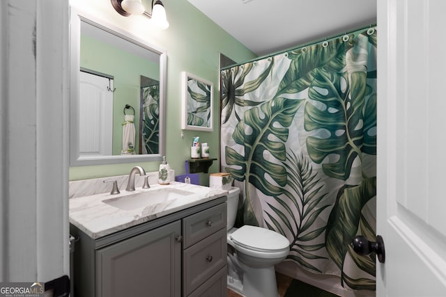 bathroom featuring toilet and vanity