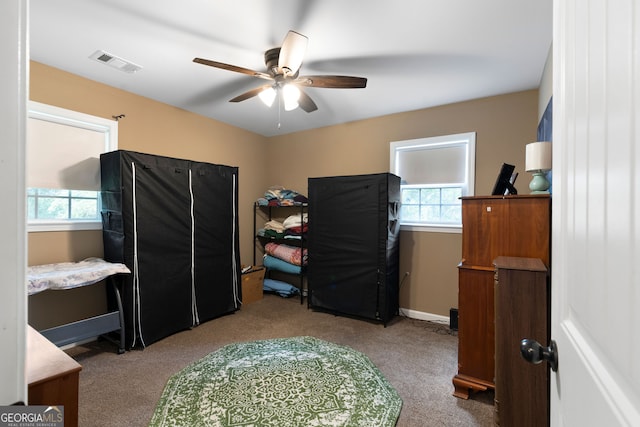 bedroom featuring multiple windows, carpet floors, and ceiling fan