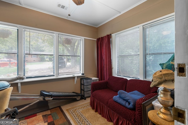 living area featuring ceiling fan, hardwood / wood-style floors, and ornamental molding