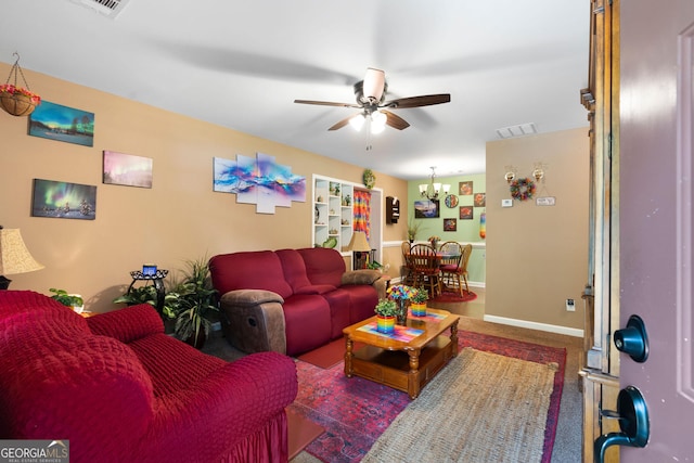 living area featuring visible vents, baseboards, carpet floors, and ceiling fan with notable chandelier