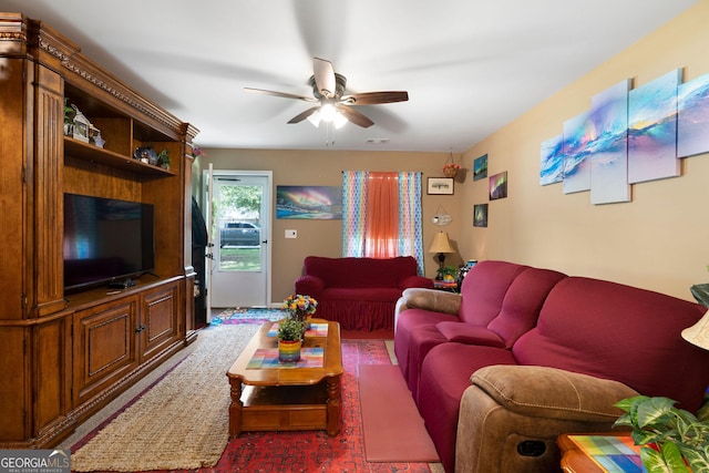 living area featuring visible vents and a ceiling fan