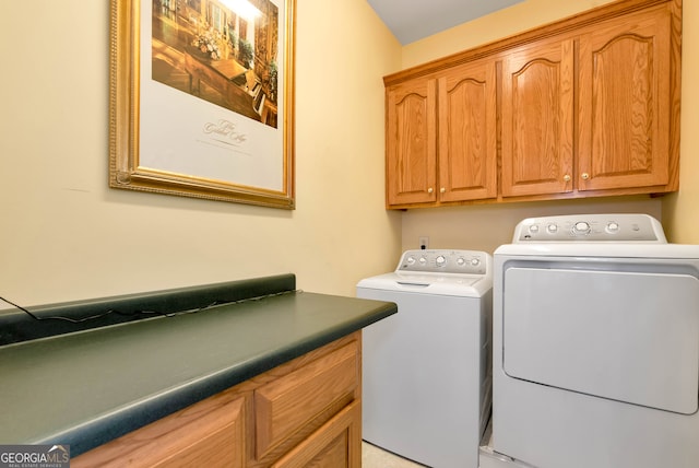 washroom featuring cabinets and washing machine and clothes dryer