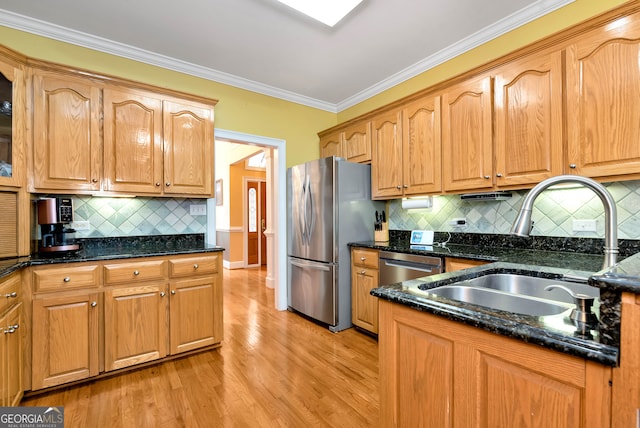 kitchen with light hardwood / wood-style floors, stainless steel refrigerator, dishwashing machine, and decorative backsplash