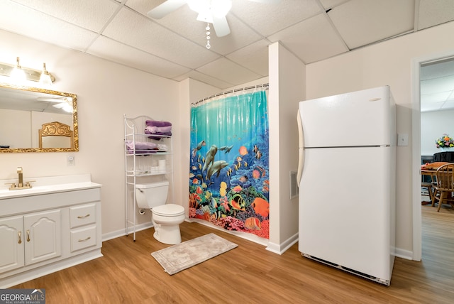 bathroom featuring ceiling fan, a paneled ceiling, and hardwood / wood-style flooring