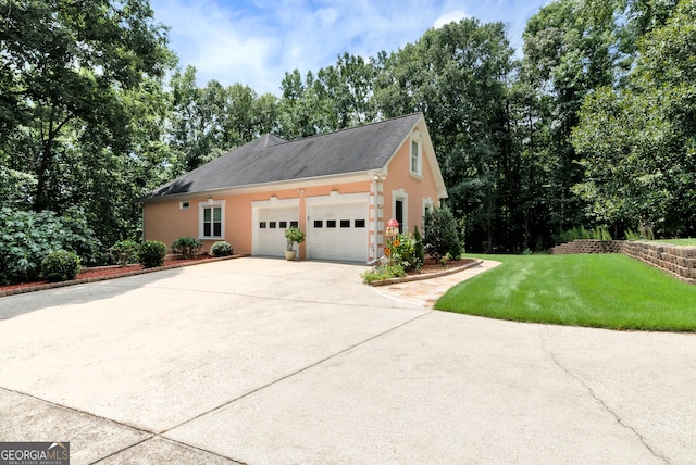 view of home's exterior featuring a garage and a lawn