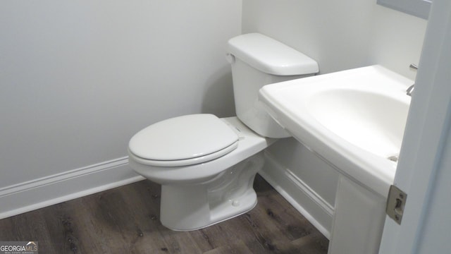 bathroom with wood-type flooring and toilet