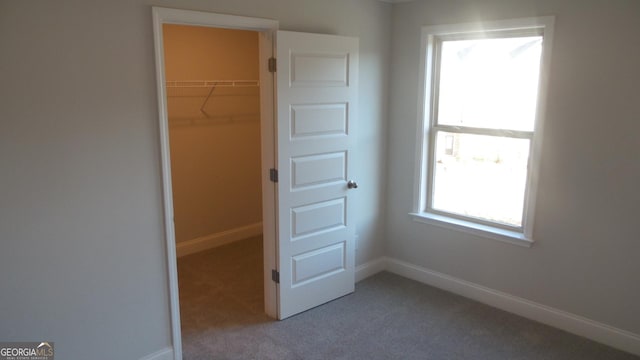 unfurnished bedroom featuring a closet and carpet