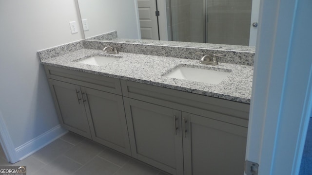 bathroom featuring vanity, a shower, and tile patterned floors