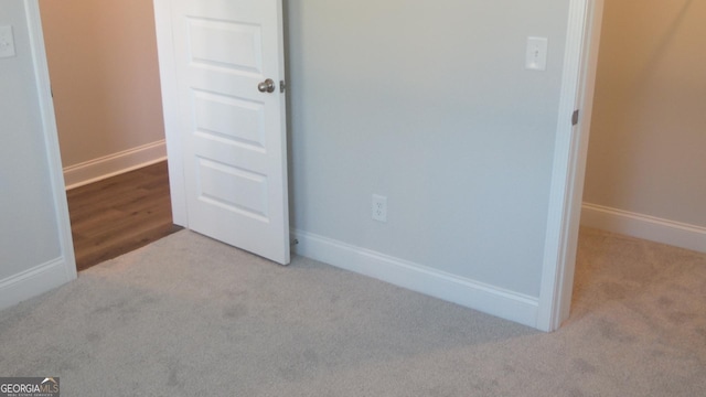 unfurnished bedroom with light colored carpet