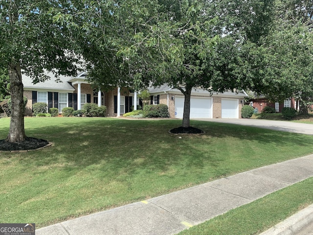 view of front of property featuring a garage and a front yard