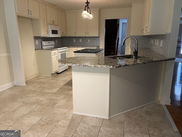 kitchen with sink, white appliances, dark stone countertops, decorative light fixtures, and kitchen peninsula