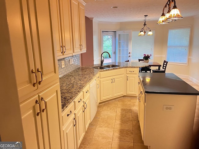 kitchen featuring sink, hanging light fixtures, light tile patterned floors, dishwasher, and decorative backsplash