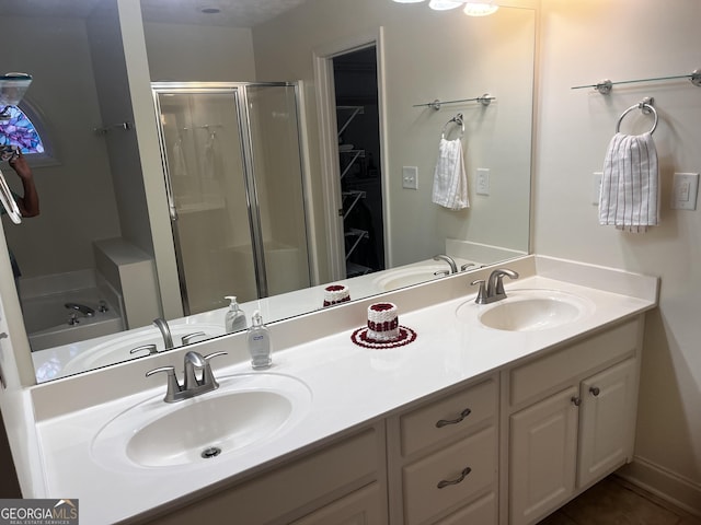 bathroom with vanity and separate shower and tub