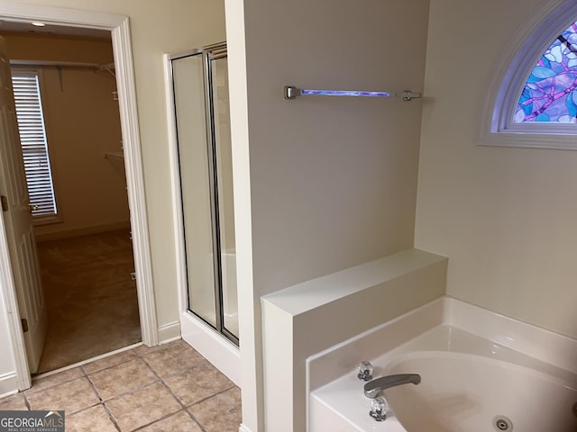 bathroom with independent shower and bath and tile patterned flooring