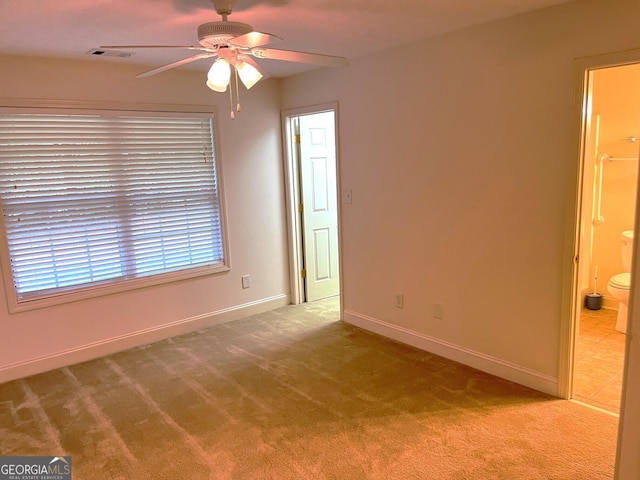 carpeted spare room with ceiling fan