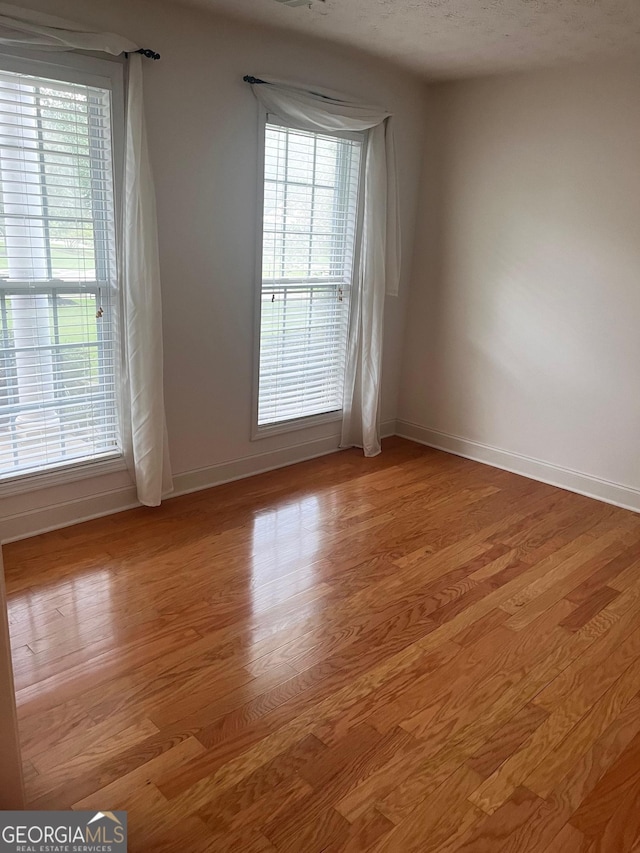 unfurnished room with light hardwood / wood-style flooring