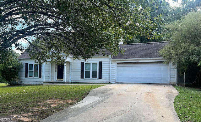 view of front of house featuring a front yard and a garage