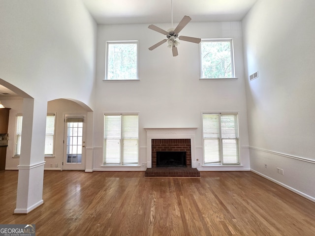 unfurnished living room featuring a wealth of natural light and a high ceiling