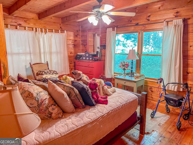 bedroom featuring wood-type flooring, ceiling fan, wooden walls, beam ceiling, and wood ceiling