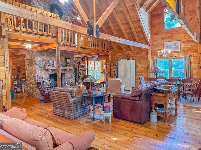 living room with beamed ceiling, high vaulted ceiling, wood walls, and hardwood / wood-style floors