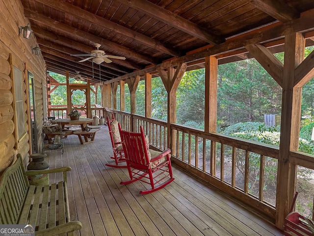 wooden terrace featuring a ceiling fan