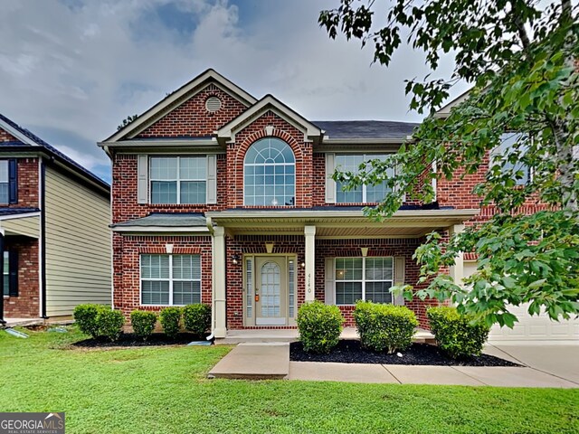 view of front facade featuring a garage and a front yard