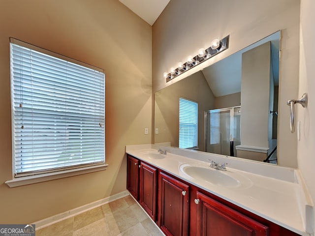 bathroom with walk in shower, tile patterned floors, vanity, and vaulted ceiling