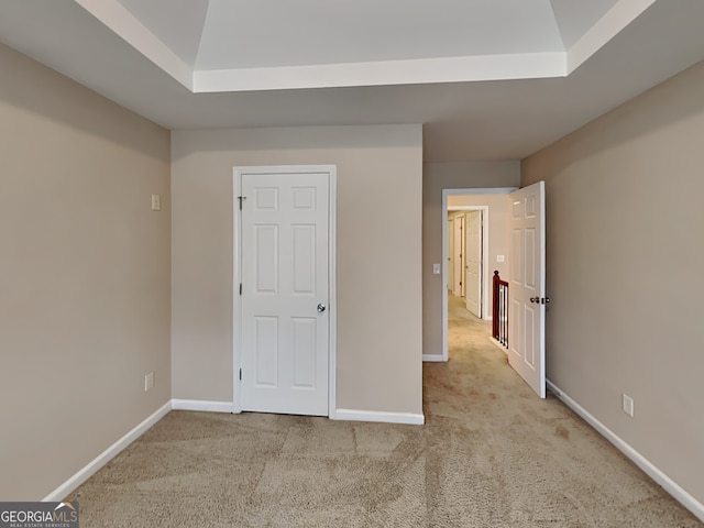 unfurnished bedroom featuring light carpet