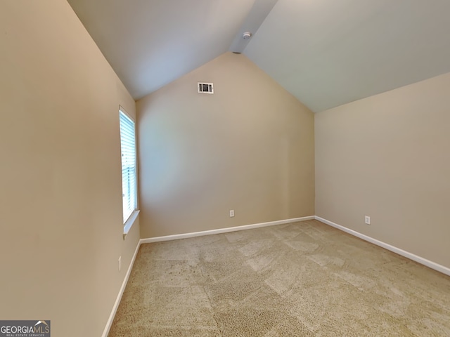 bonus room with lofted ceiling and light colored carpet