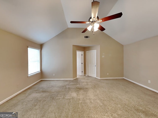 carpeted spare room with lofted ceiling and ceiling fan