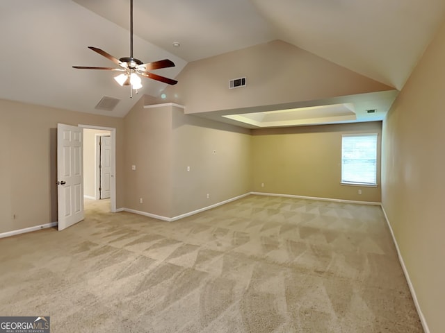 carpeted empty room with vaulted ceiling and ceiling fan