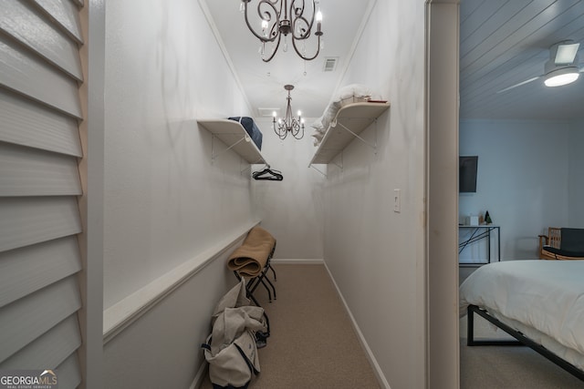 interior space featuring an inviting chandelier, carpet, and crown molding