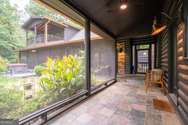 unfurnished sunroom with wood ceiling and ceiling fan