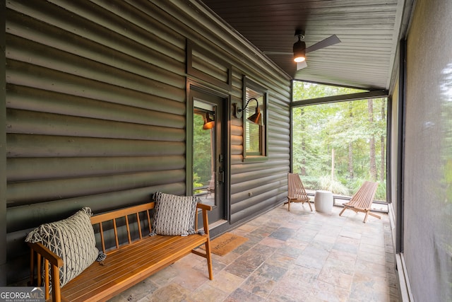 sunroom / solarium featuring ceiling fan