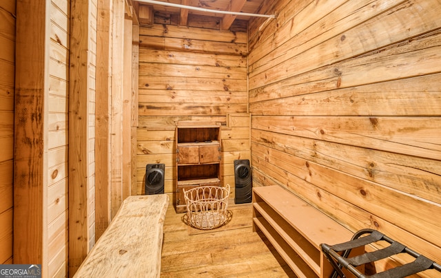 view of sauna featuring wood-type flooring and wood walls