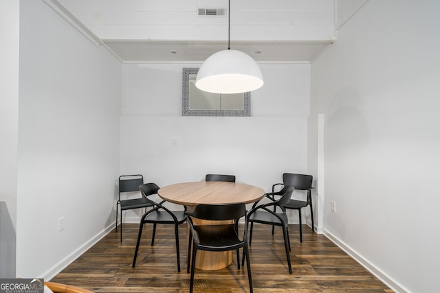 dining area with dark hardwood / wood-style flooring