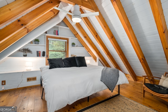 bedroom featuring lofted ceiling with beams, light hardwood / wood-style flooring, and ceiling fan