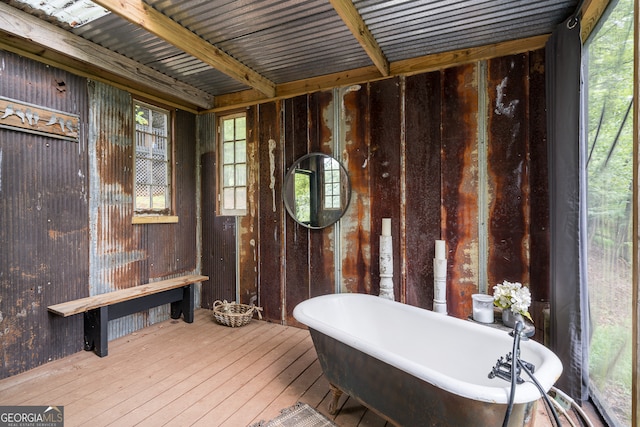 bathroom featuring a tub to relax in and hardwood / wood-style floors