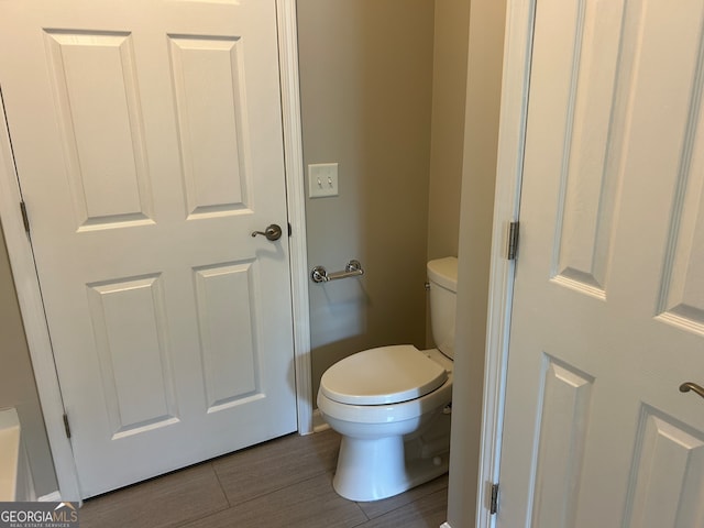 bathroom featuring toilet and tile patterned flooring