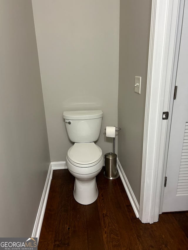 bathroom featuring wood-type flooring and toilet