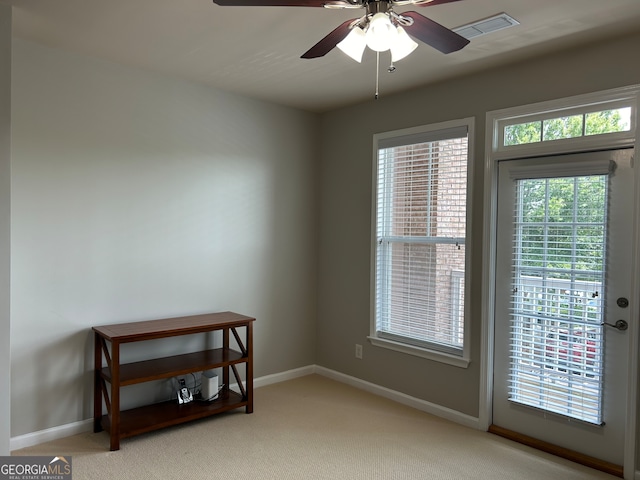 unfurnished room with ceiling fan and carpet floors